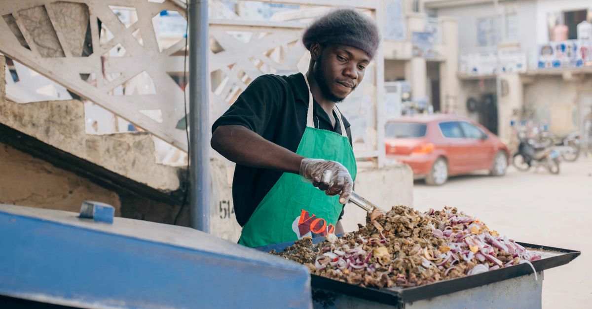 Christ Embassy Ho Loveworld Arena food preparation area with volunteers serving jollof rice