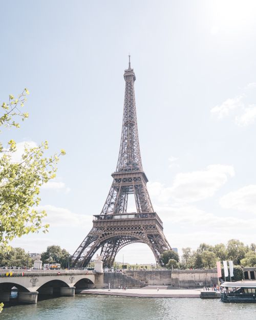 Free Iconic Eiffel Tower photographed from across the Seine River under a clear day sky in Paris, France. Stock Photo
