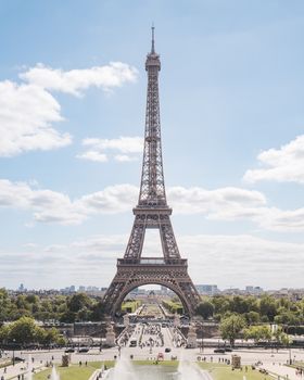 Beautiful daytime view of the Eiffel Tower in Paris, France capturing its grandeur and surroundings.