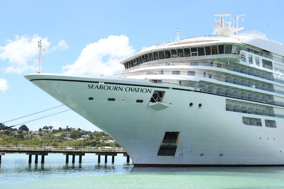 Seabourn Ovation cruise ship docked in Saint John, Antigua under a bright blue sky.