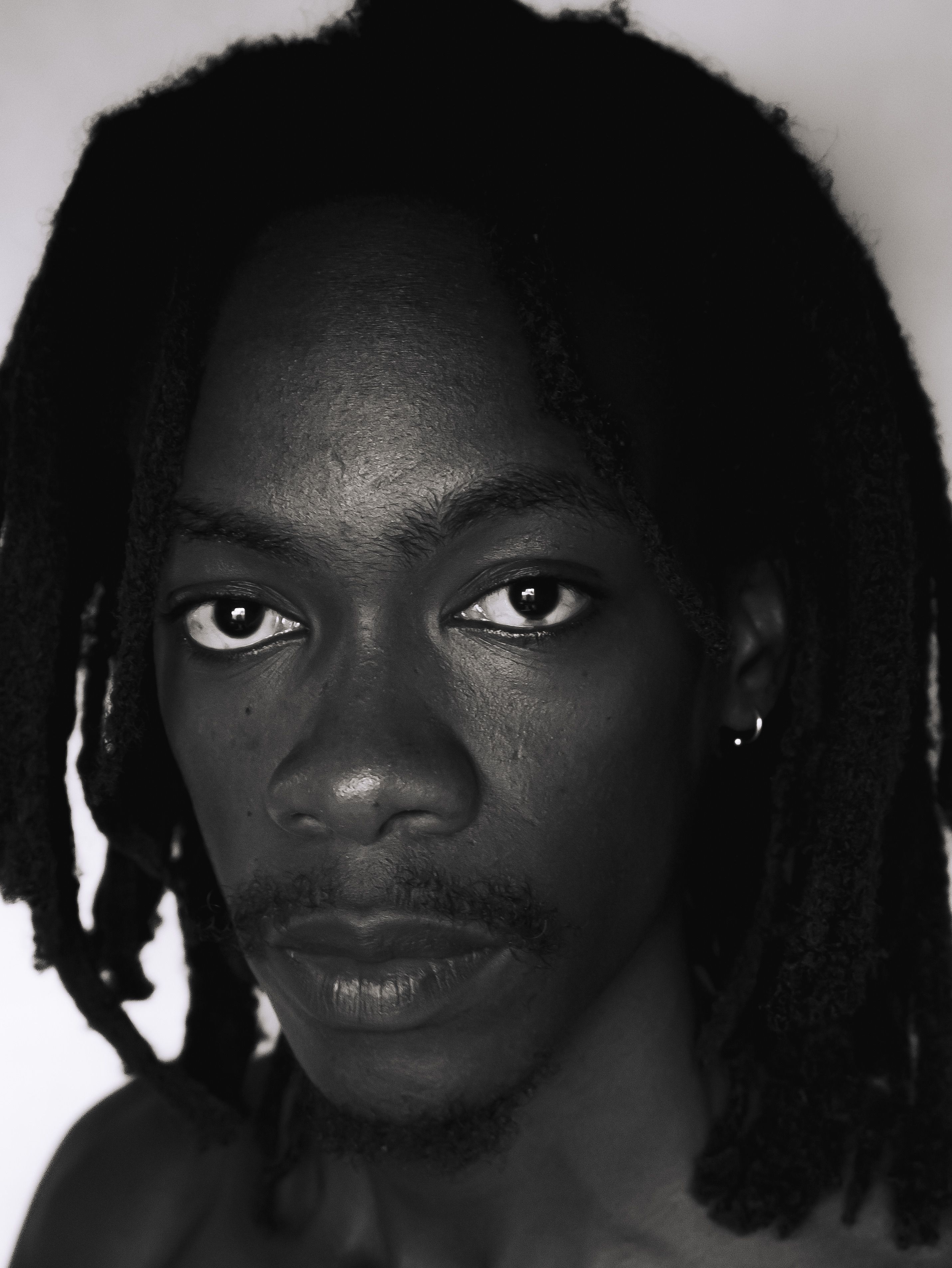 Black and White Portrait of a Young Man with Dreadlocks · Free Stock Photo