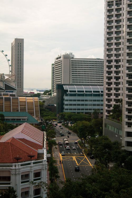 Free Aerial view of a bustling city road in Singapore flanked by modern skyscrapers on a cloudy day. Stock Photo
