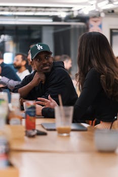 Two professionals in discussion, showcasing teamwork in a contemporary office setting.