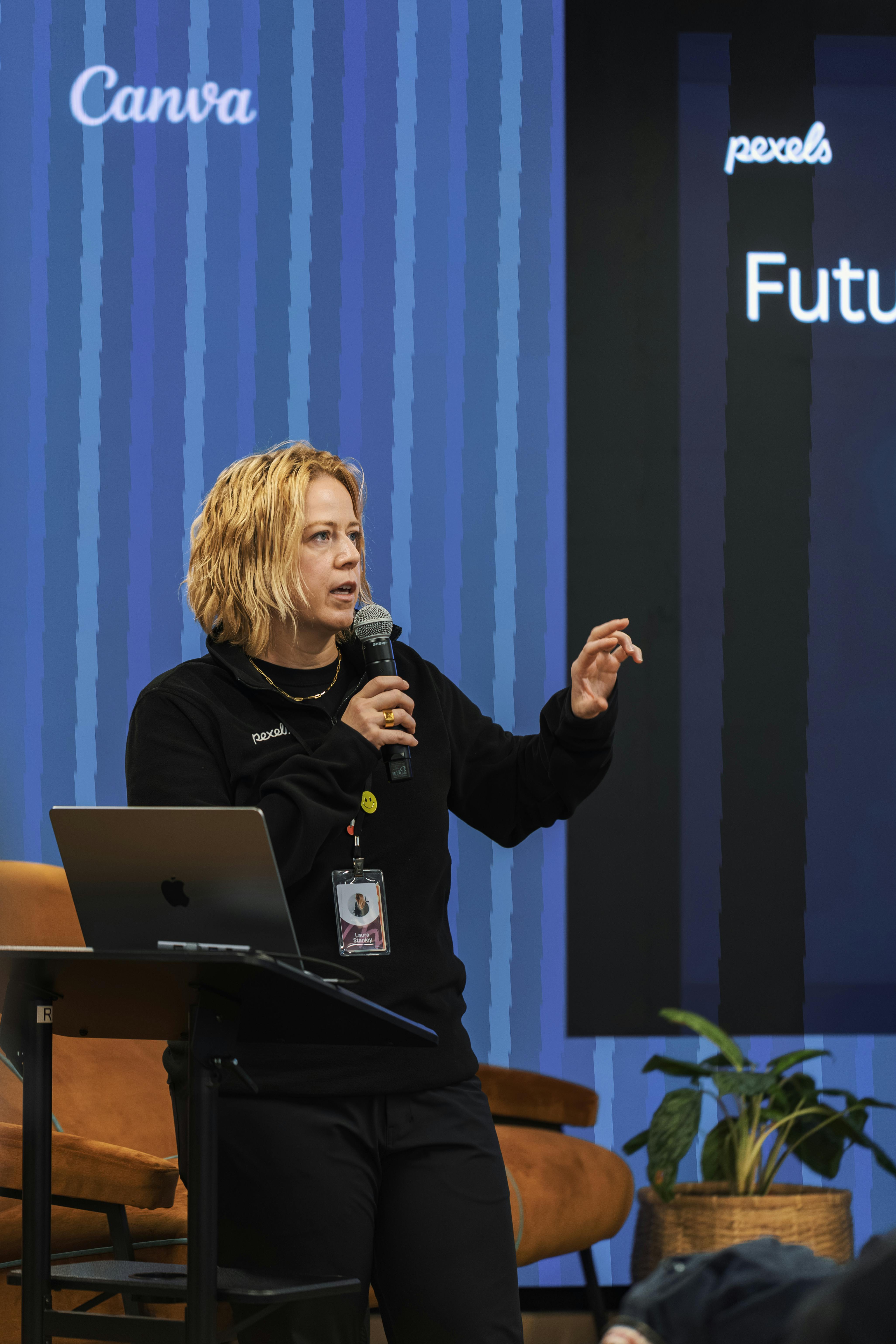 A speaker engages the audience during a tech conference, discussing future trends.