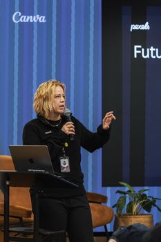 A speaker engages the audience during a tech conference, discussing future trends.