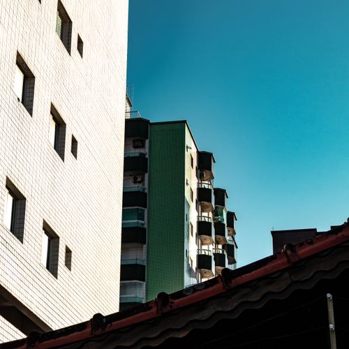 Free Urban skyline of Praia Grande, Brazil, featuring modern architecture against a clear blue sky. Stock Photo