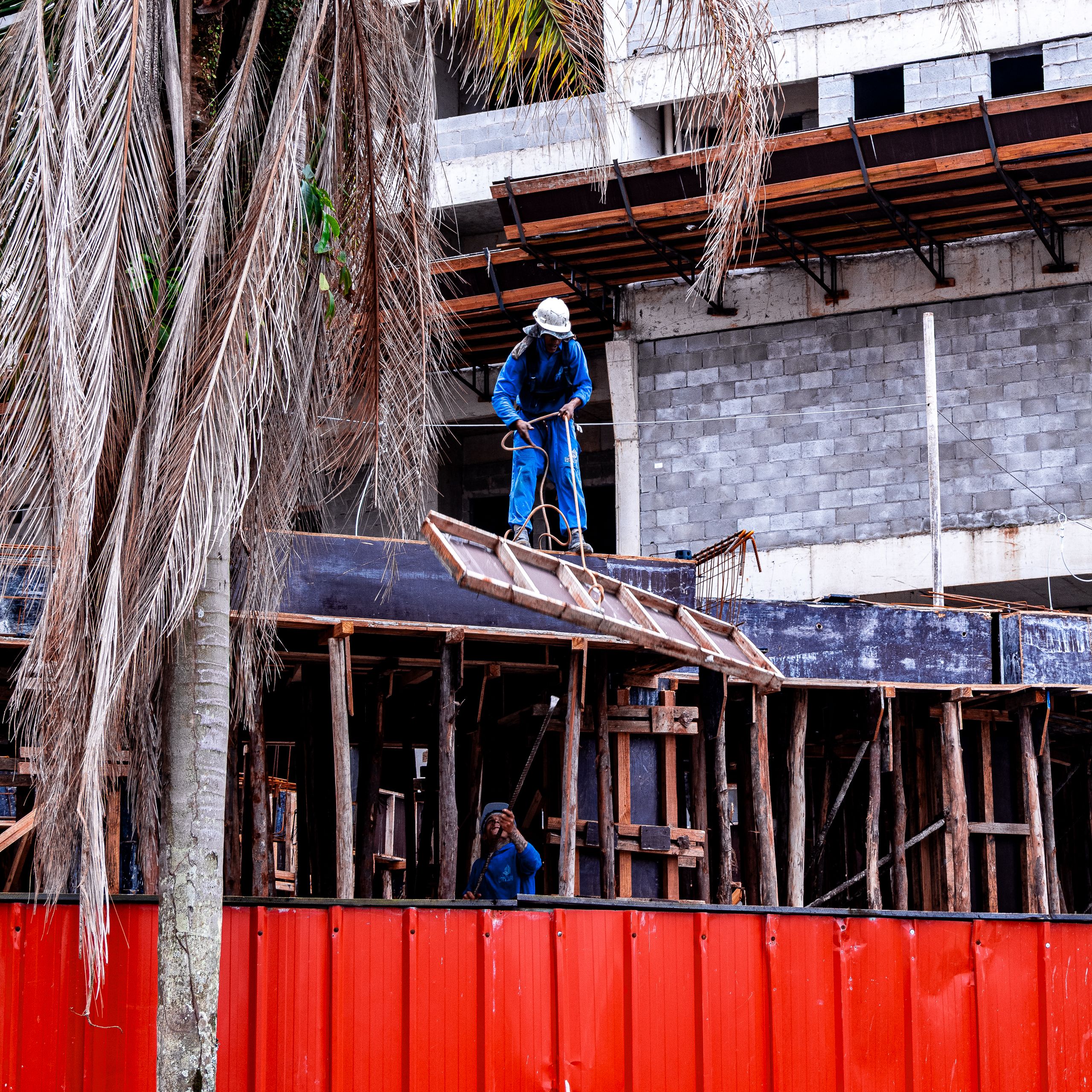 Construction workers on scaffolding at a building site in Praia Grande, São Paulo, Brazil.