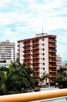 High-rise residential buildings surrounded by palm trees in Praia Grande, São Paulo, Brasil.