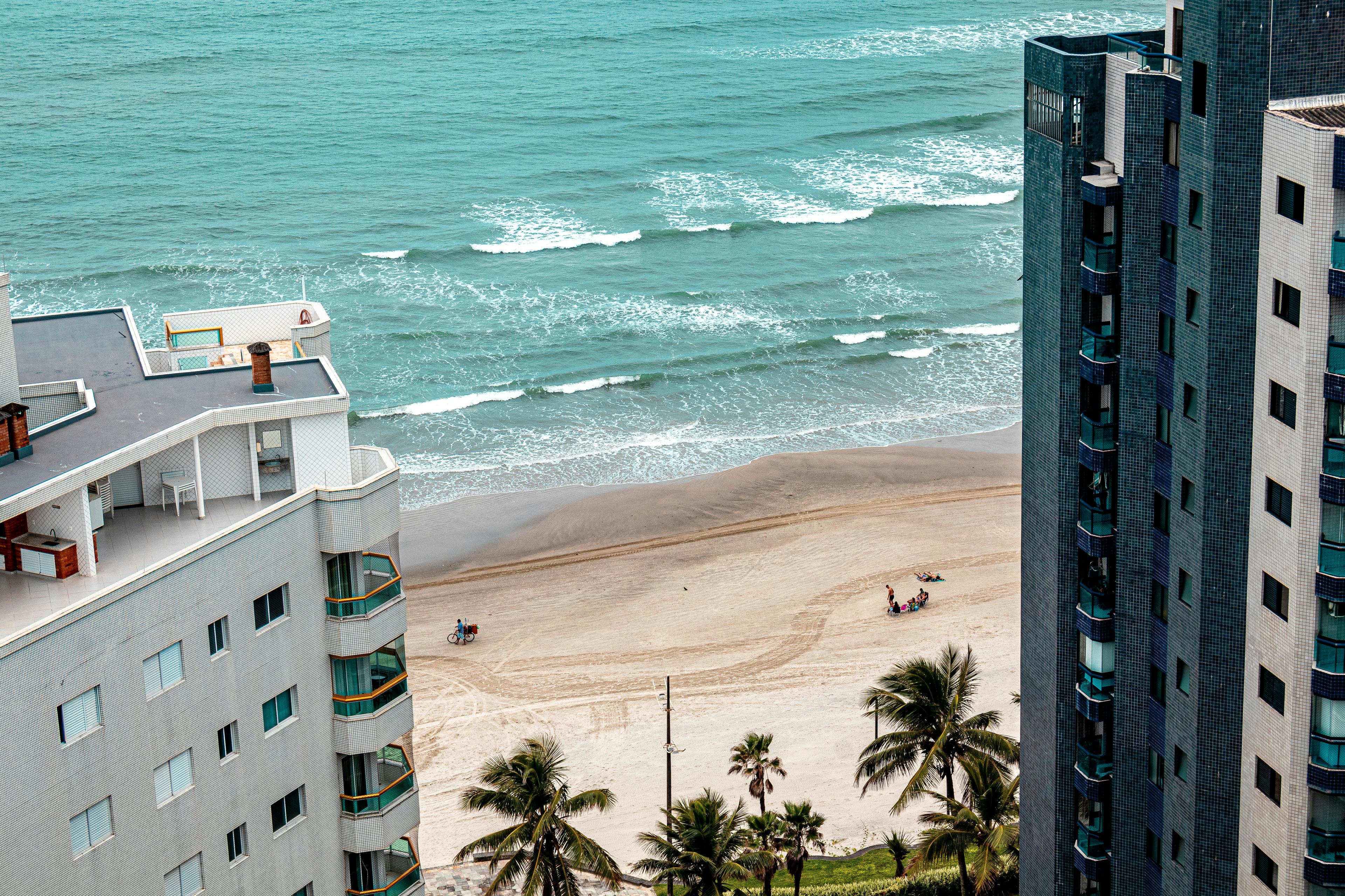 Aerial view of Praia Grande beach with skyscrapers and coastline in São Paulo, Brazil.