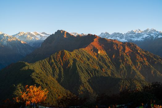 Capture the majestic view of the Himalayan mountains in Nepal during sunrise.