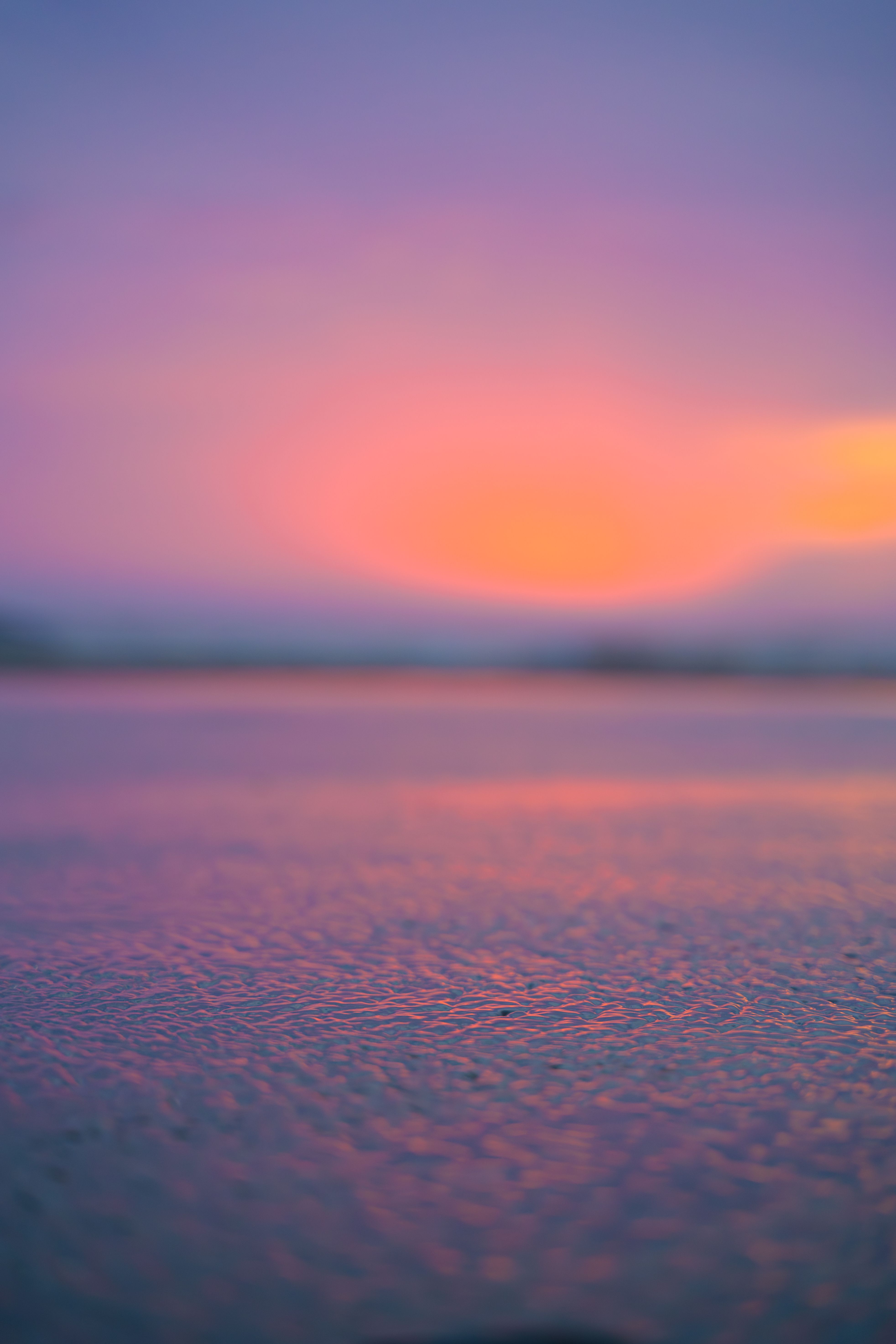 A stunning view of a vibrant sunset reflecting on calm ocean waters, perfect for creating a serene atmosphere.