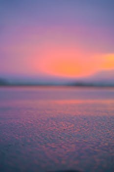 A stunning view of a vibrant sunset reflecting on calm ocean waters, perfect for creating a serene atmosphere.