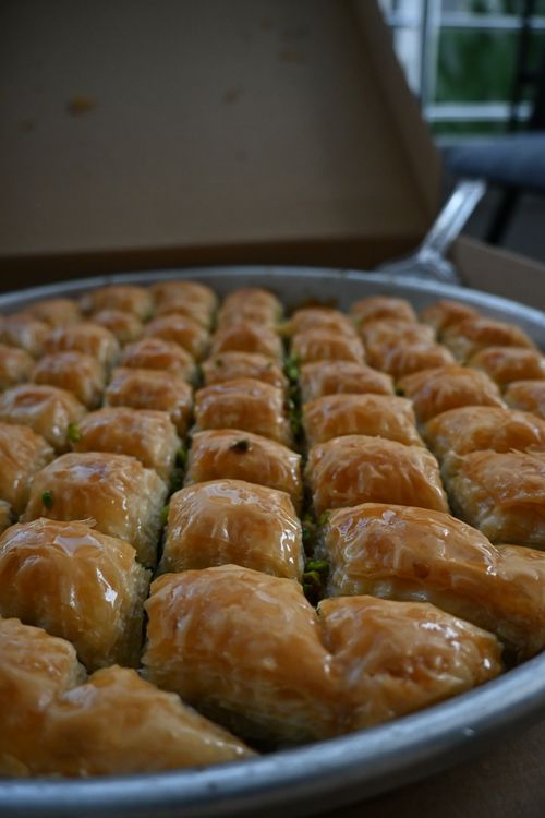 Free Close-up of a tray filled with golden, flaky baklava, perfect for dessert lovers. Stock Photo