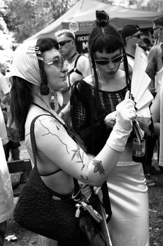 Stylish individuals at an outdoor event embracing bold fashion.