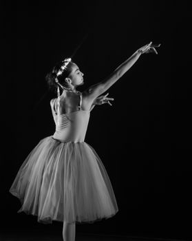 Capture of a graceful ballerina performing in a classic black and white setting.