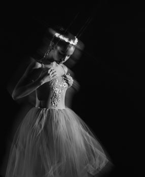 Captivating black and white image of a ballerina captured in a graceful motion blur.