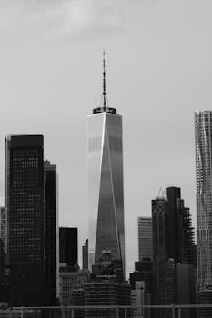Monochrome image of One World Trade Center among New York skyscrapers.