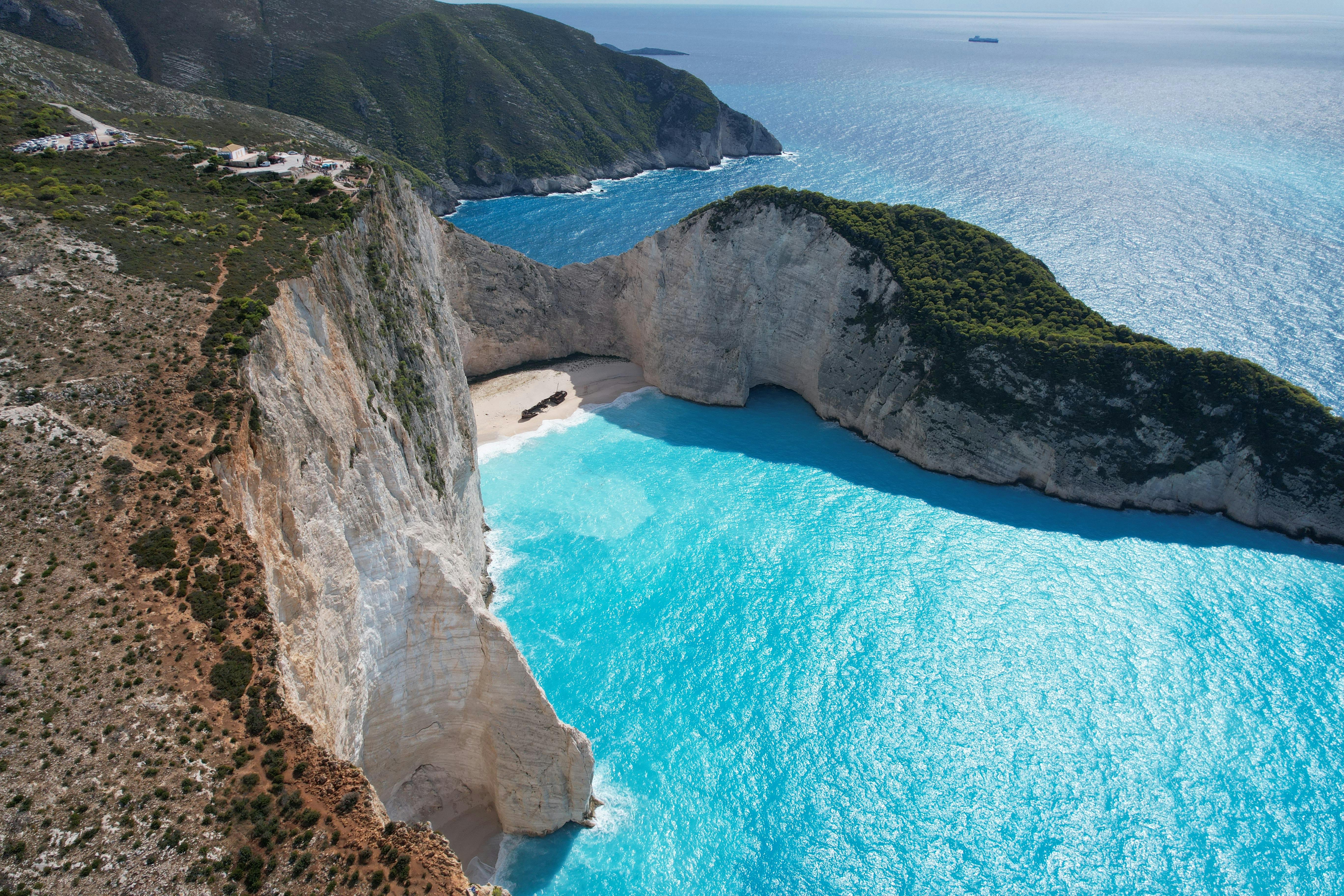A breathtaking aerial view of Navagio Beach's iconic cliffs and turquoise waters in Greece.
