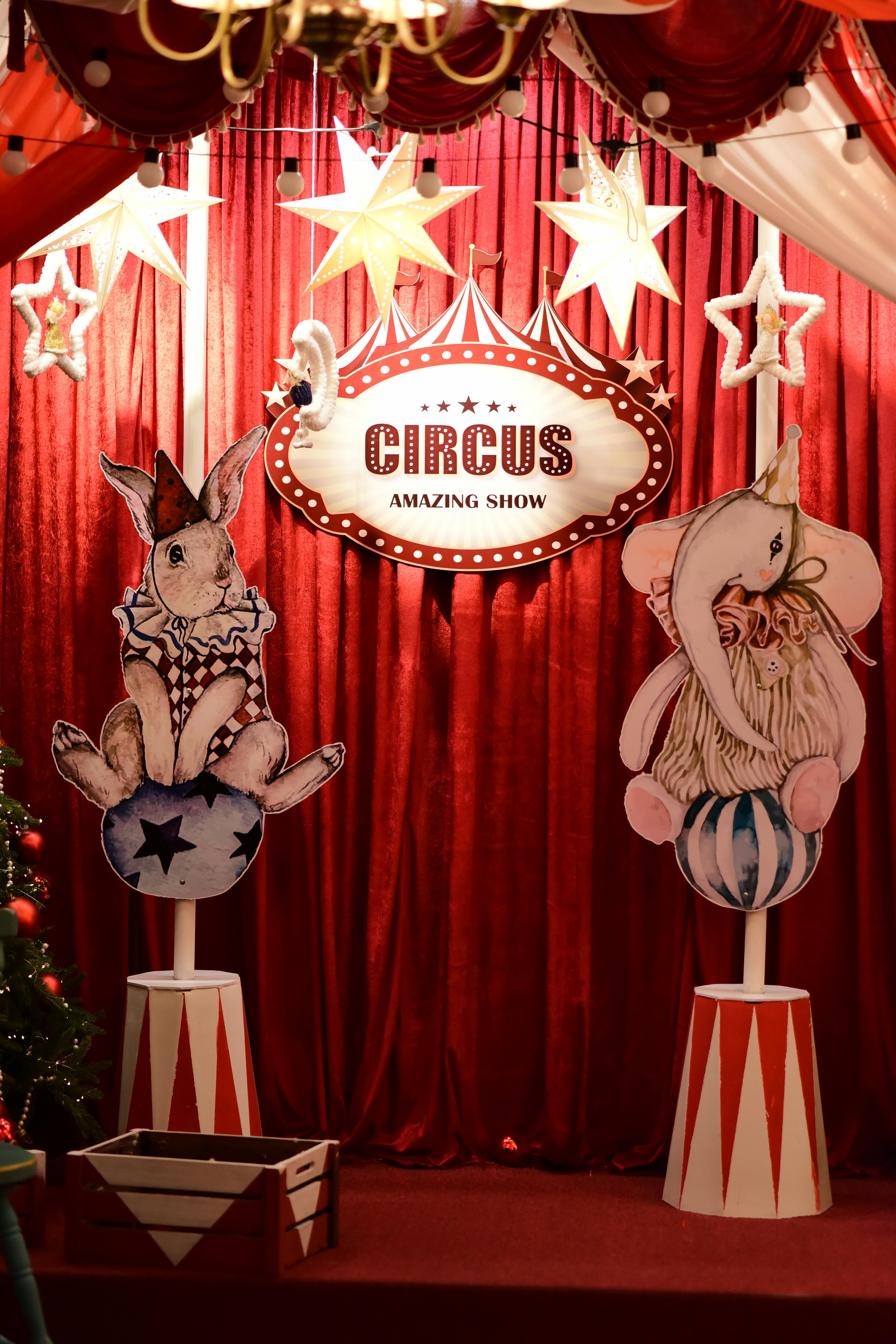 Free Whimsical circus-themed decoration with rabbit and elephant on pedestals. Stock Photo