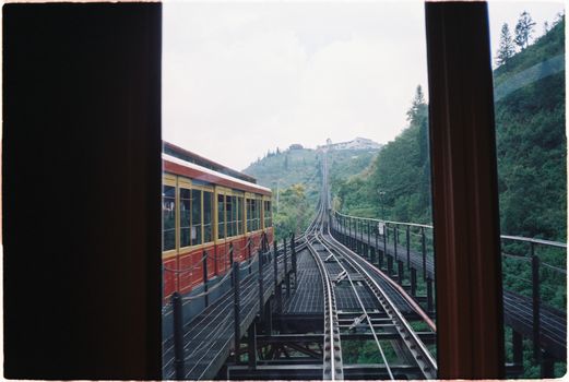 View from a train overlooking lush hills in Lao Cai, Vietnam, capturing a scenic travel moment.