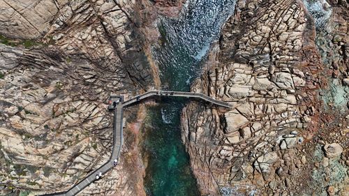 Free A stunning aerial view of Gracetown's rocky coastline and pedestrian walkway in Western Australia. Stock Photo