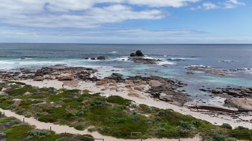 Free A breathtaking aerial view of Western Australia's rocky coastline and pristine blue waters. Stock Photo