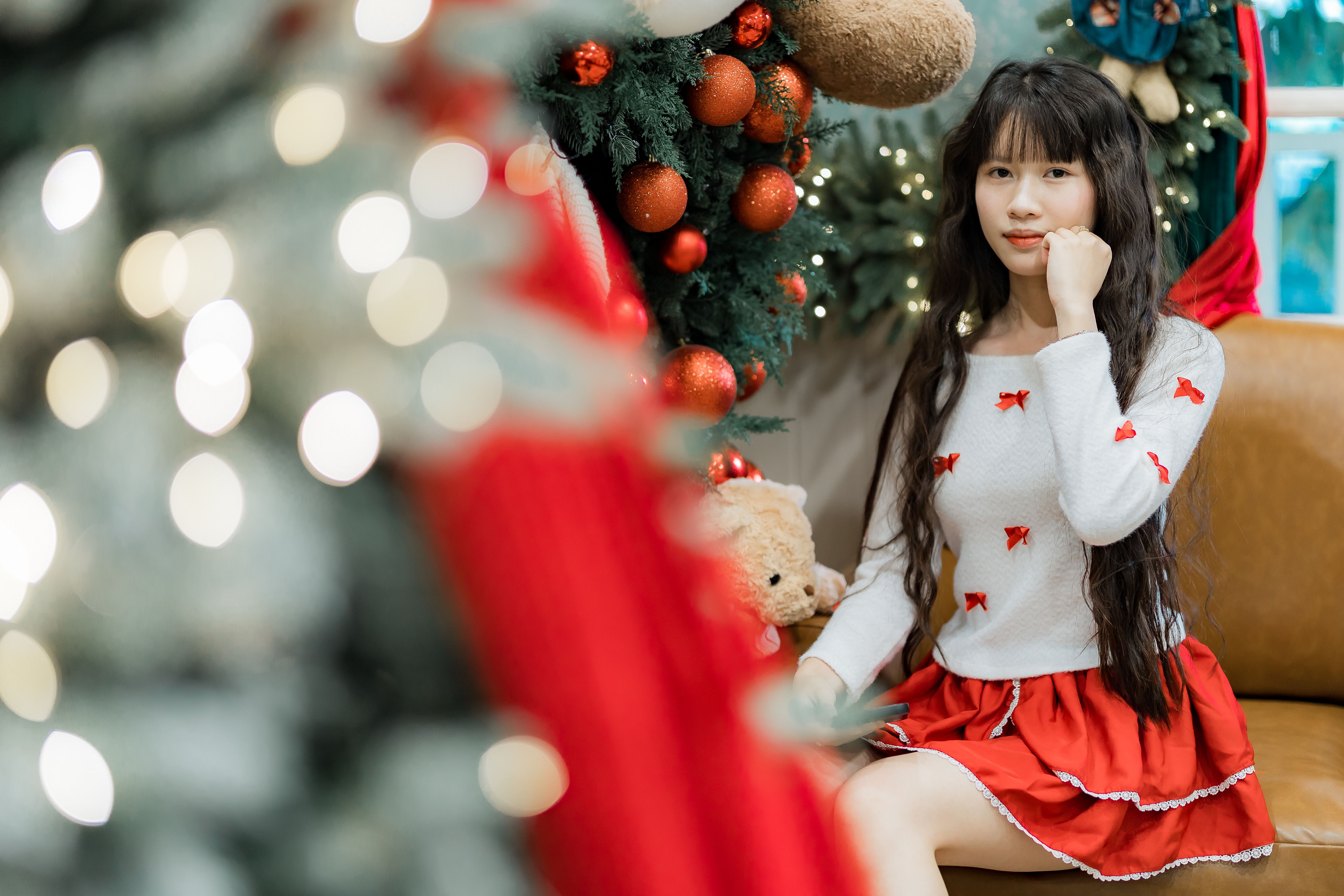 Festive Young Woman Posing by Christmas Tree · Free Stock Photo