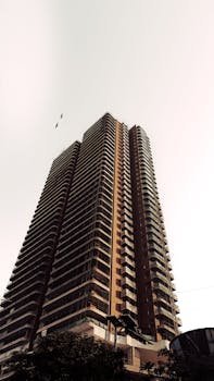 Tall skyscraper with modern architecture and clear sky background, urban cityscape.