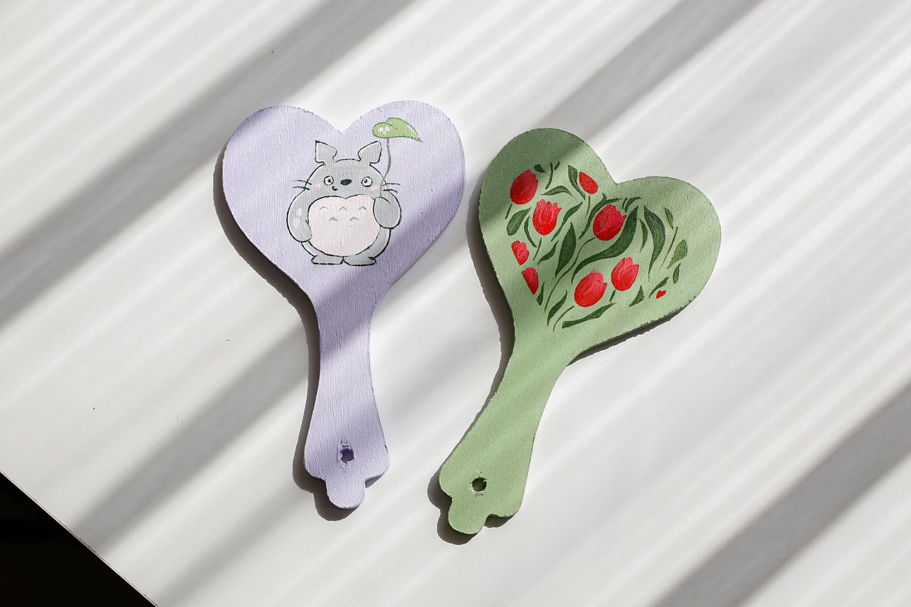 pair of heart shaped hand fans featuring cute illustrations perfect fo