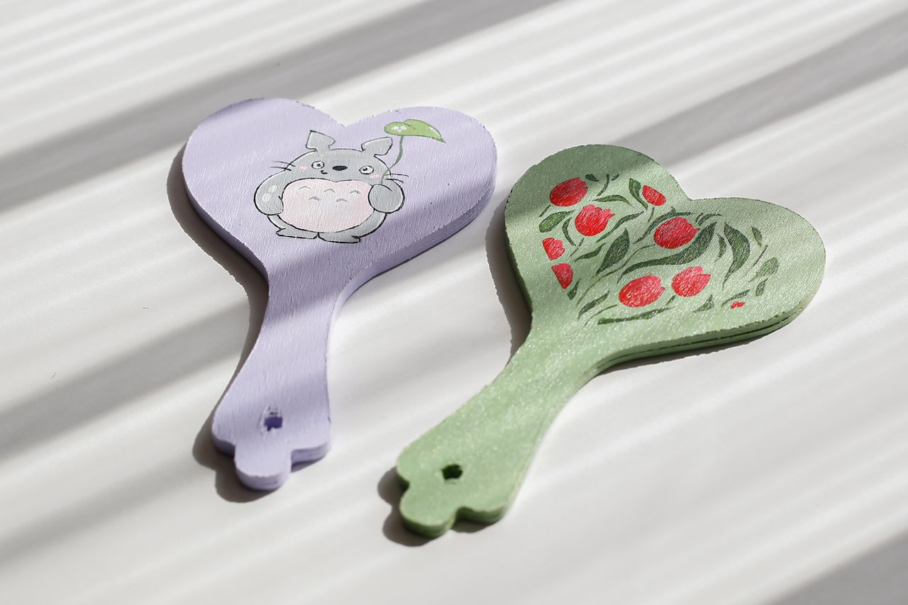 pair of heart shaped hand mirrors with whimsical and floral painted de