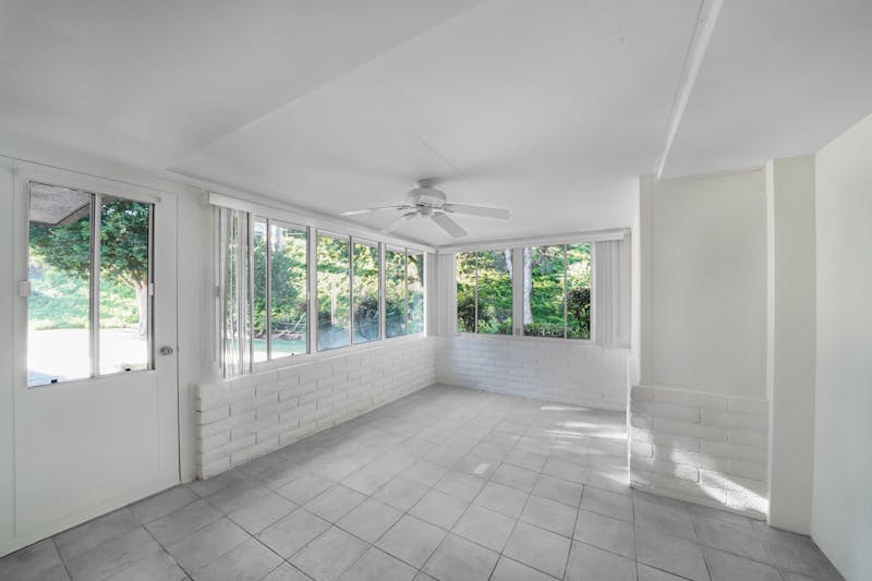 Home addition with sunroom and large windows