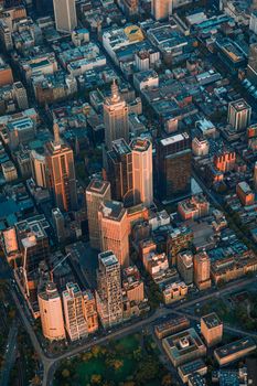 Stunning aerial shot of Melbourne with iconic skyscrapers and vibrant city layout at sunset.