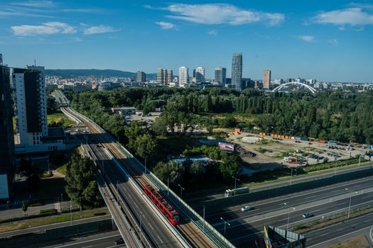 A vibrant cityscape of Bratislava with modern architecture and public transport.