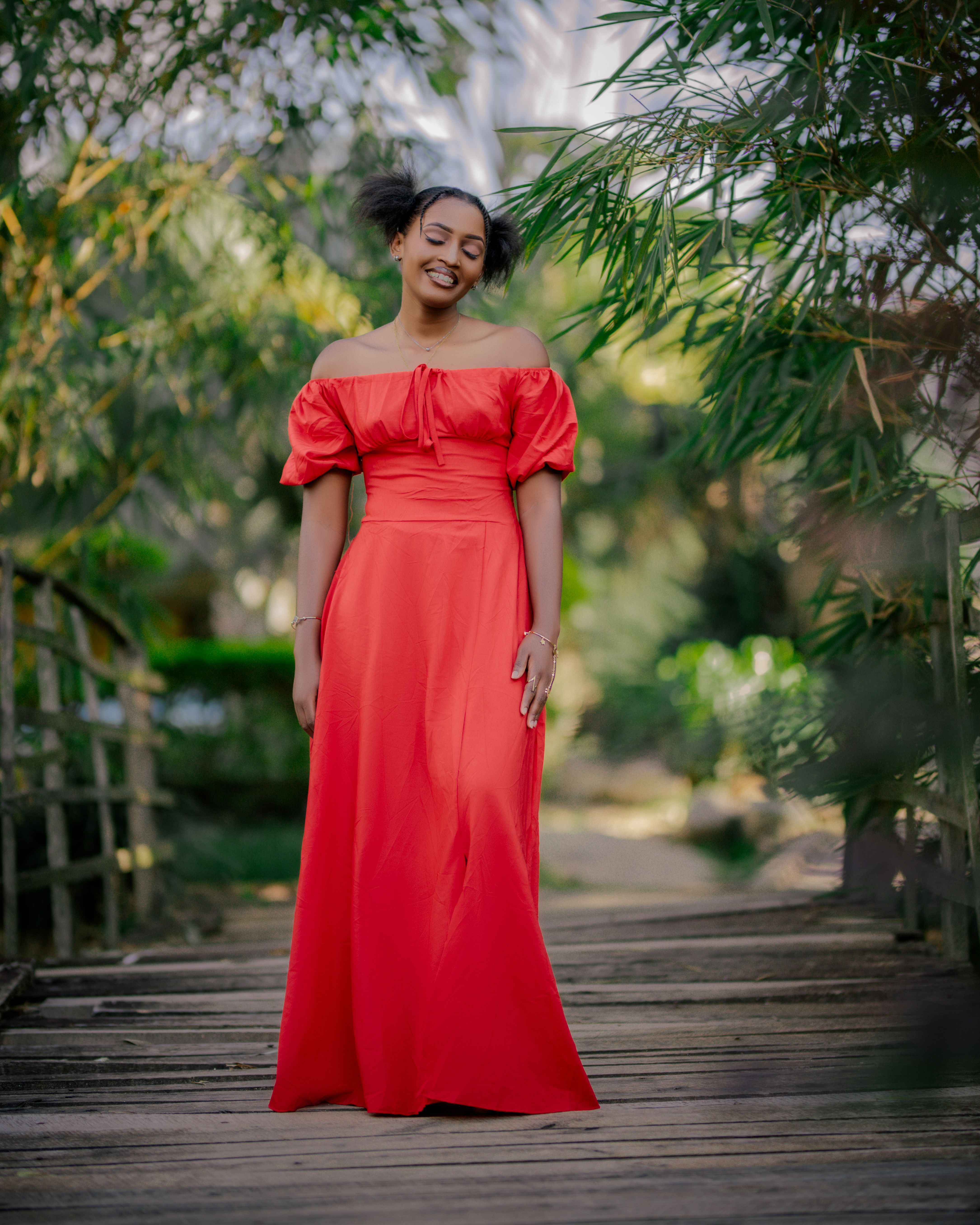 Elegant Woman in Red Dress in Garden Setting · Free Stock Photo