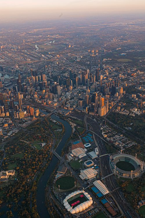 Free A breathtaking aerial view of Melbourne city skyline and Yarra River at sunrise. Stock Photo