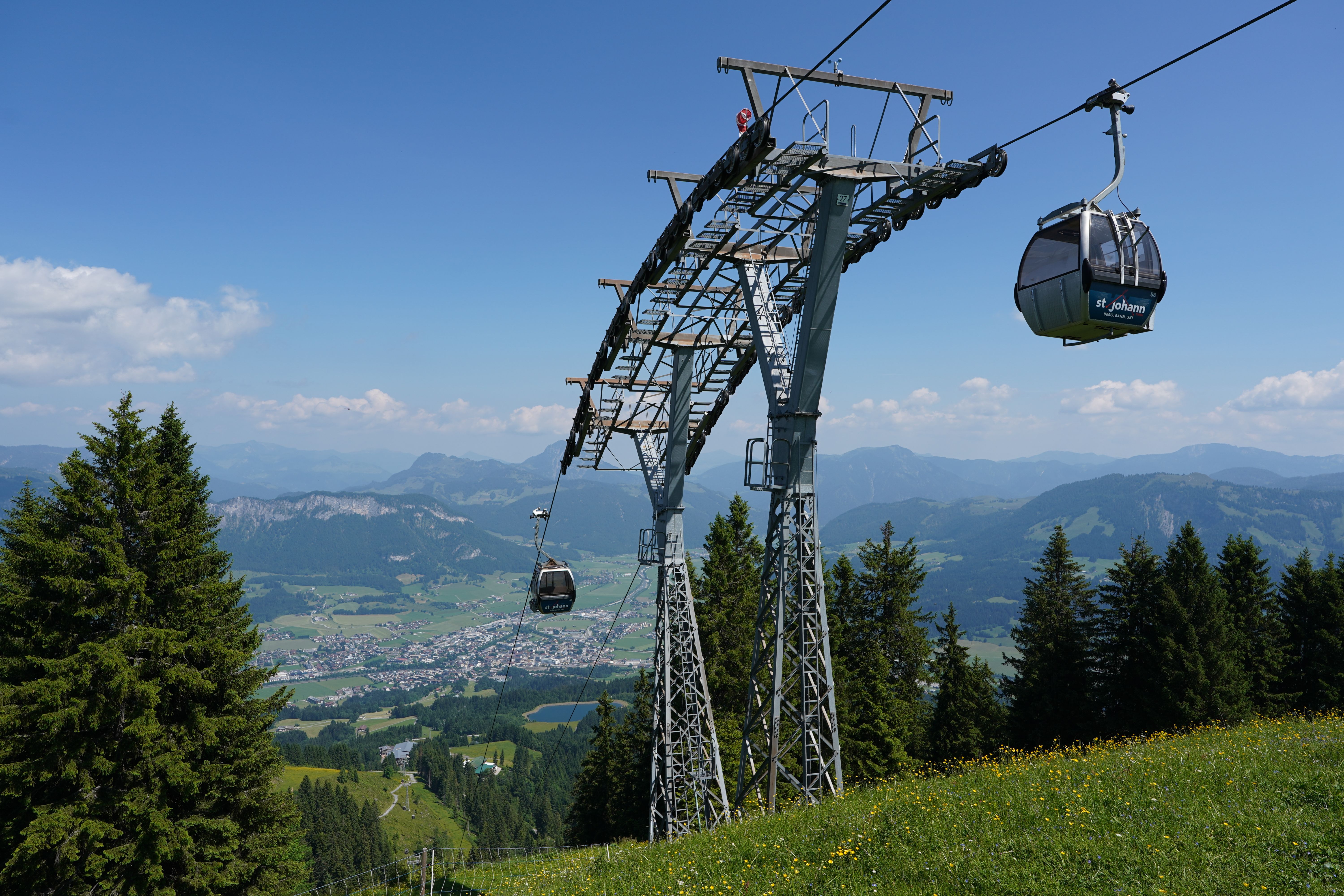 Idyllic view of a gondola lift in Sankt Johann, Tyrol, with mountains in the background.