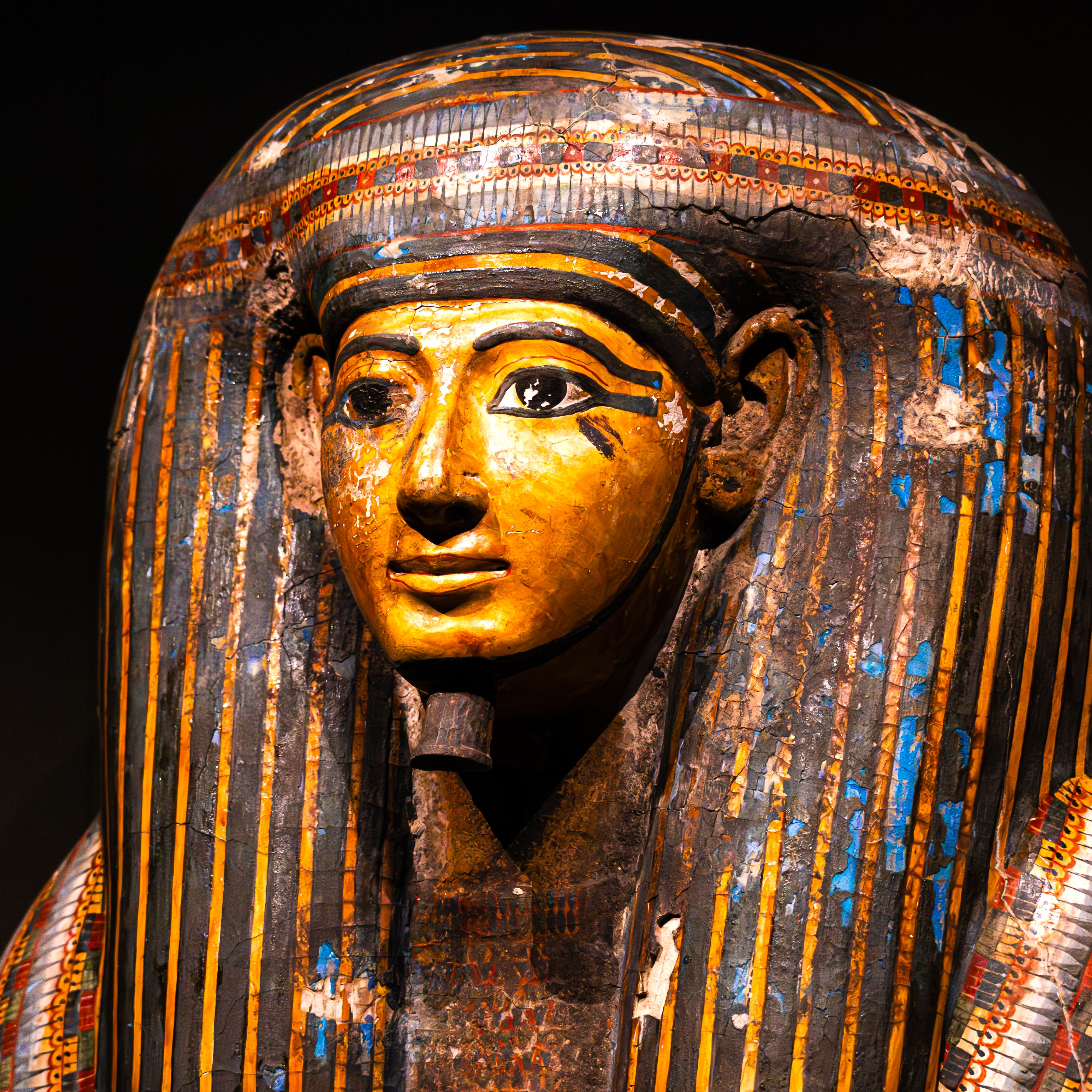 Detailed view of an ancient Egyptian sarcophagus, showcasing intricate artistic design and historical significance.