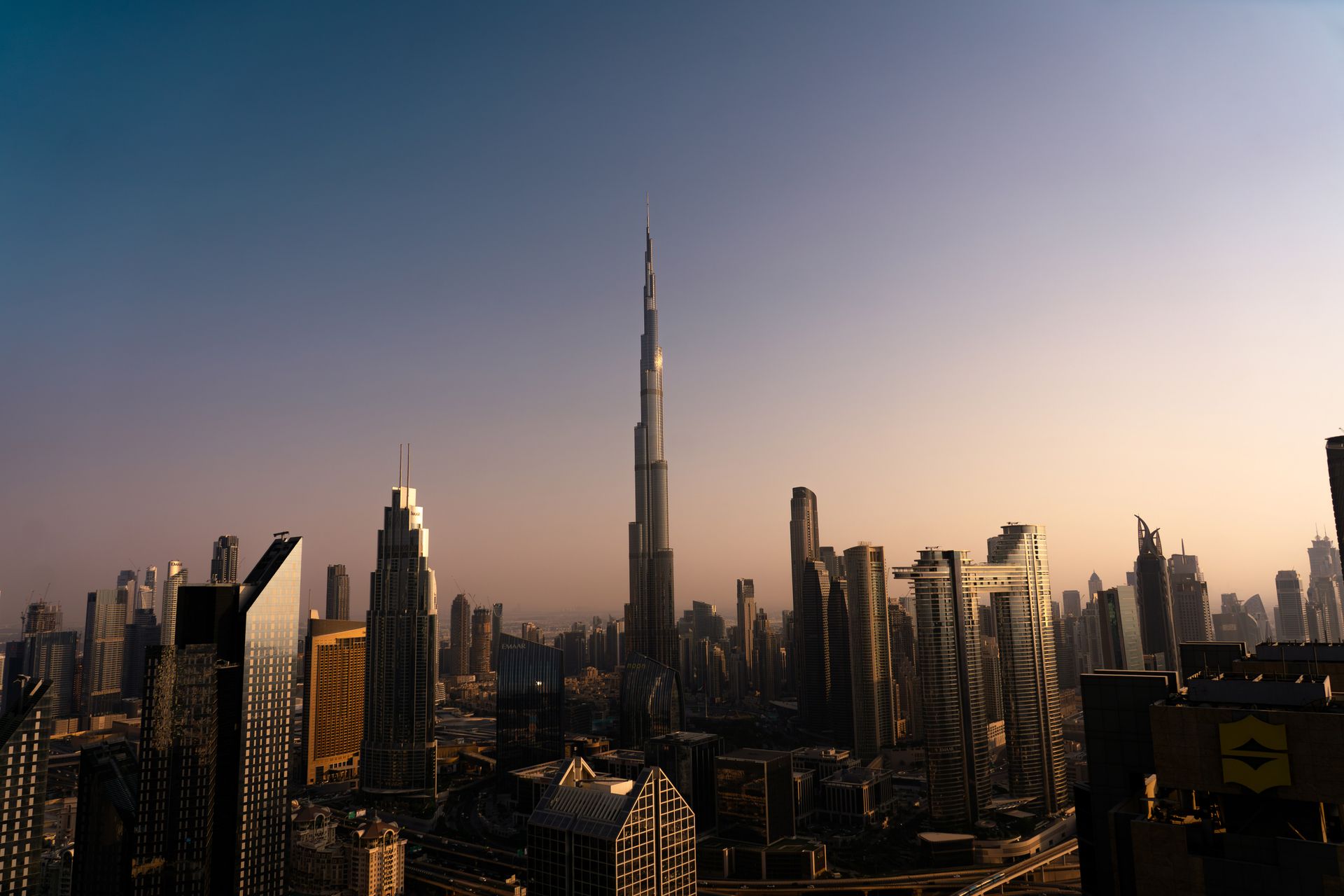 Stunning view of Dubai's skyline with the Burj Khalifa at sunset, capturing the city's modern archit