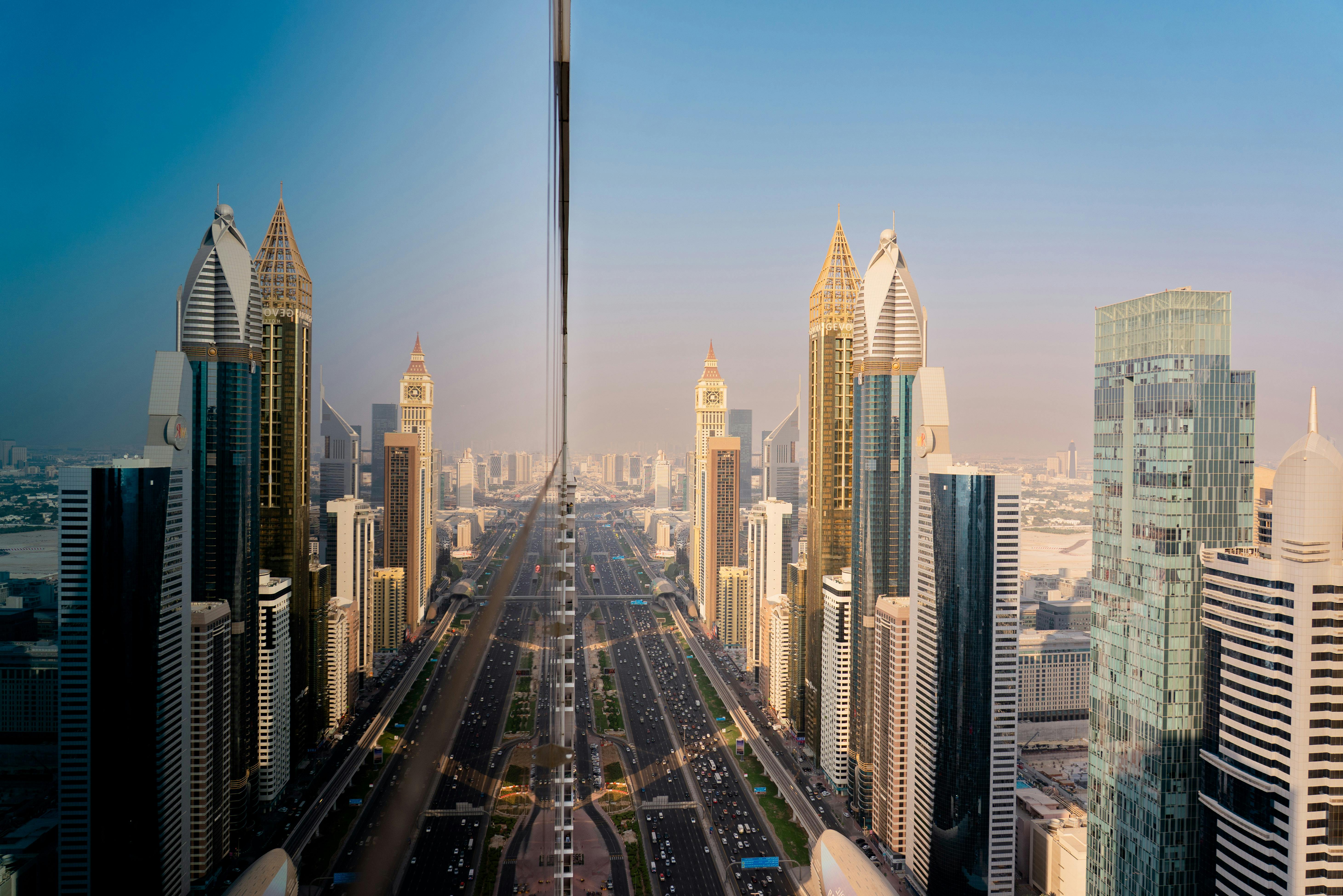 Sharjah and Dubai skyline traffic at night with light trails on Sheikh Zayed Road