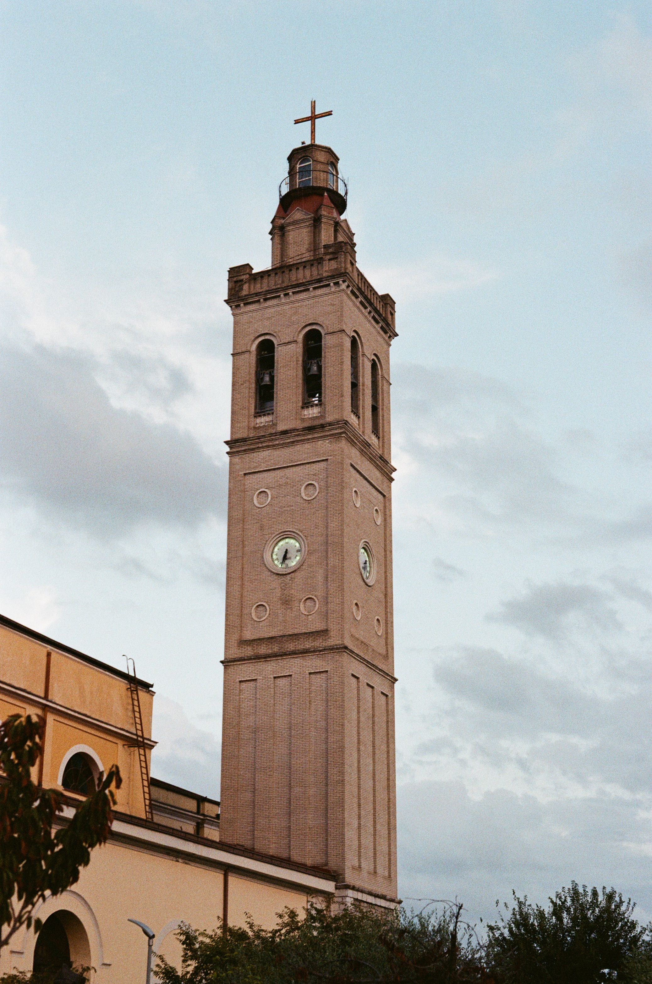 Historic Church Tower Against Cloudy Sky · Free Stock Photo
