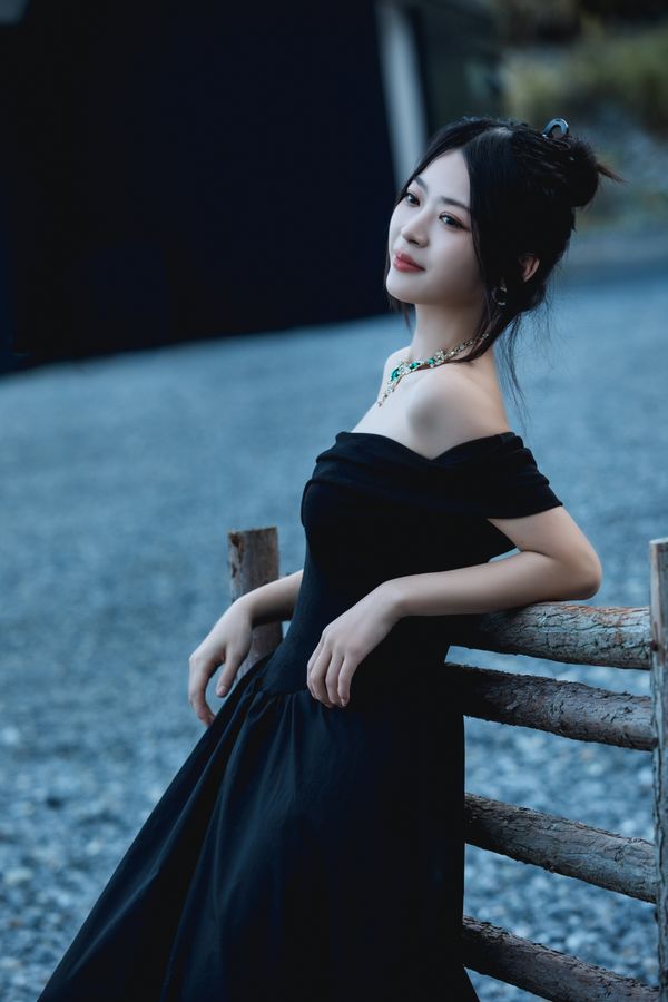 Woman in a black dress with statement sleeves