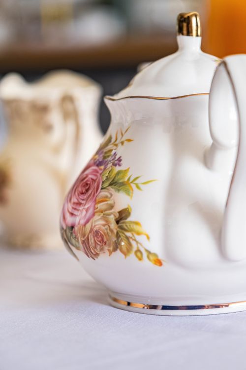 Free Close-up of a classic floral teapot with a blurred background. Fine elegance for tea time. Stock Photo