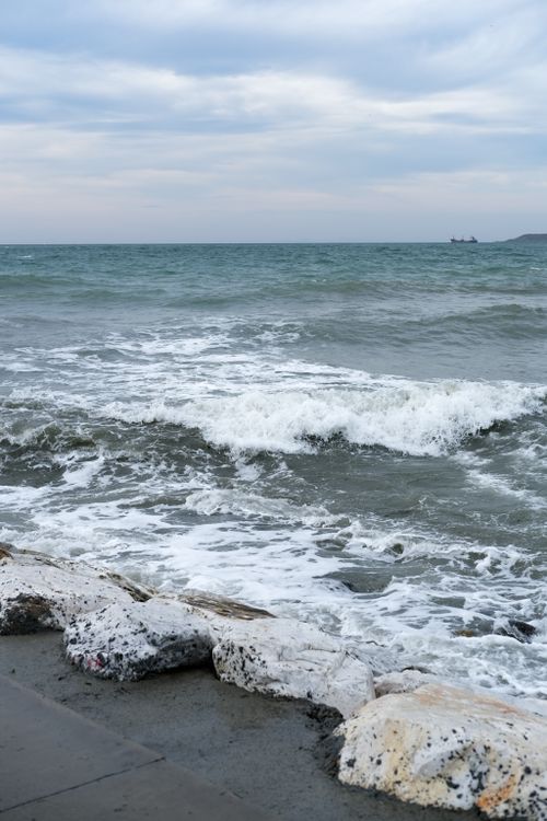 Free Tranquil seascape of waves hitting the rocky shore at Büyükçekmece, İstanbul. Stock Photo