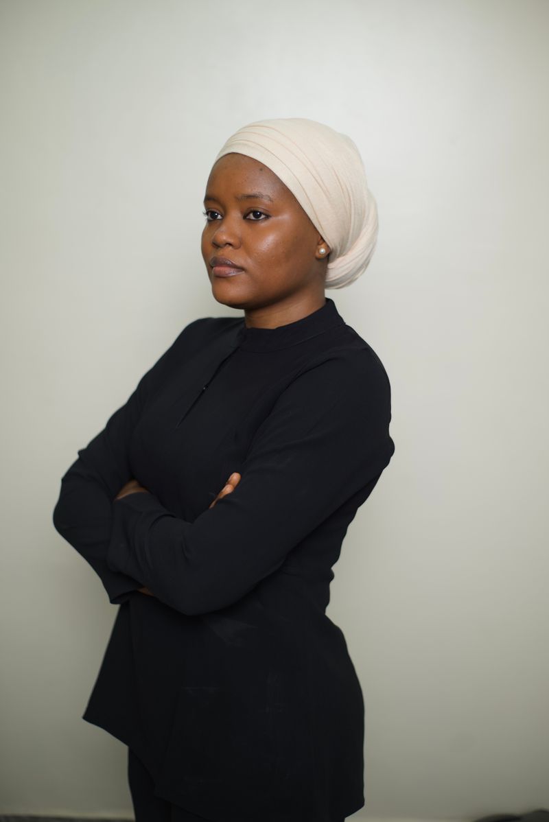 Professional standing with arms crossed, photo by Taiye Salawu on Pexels
