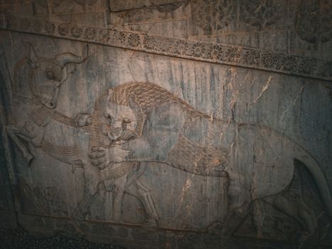 Intricate bas relief of lion and bull at Persepolis, UNESCO World Heritage Site in Iran.