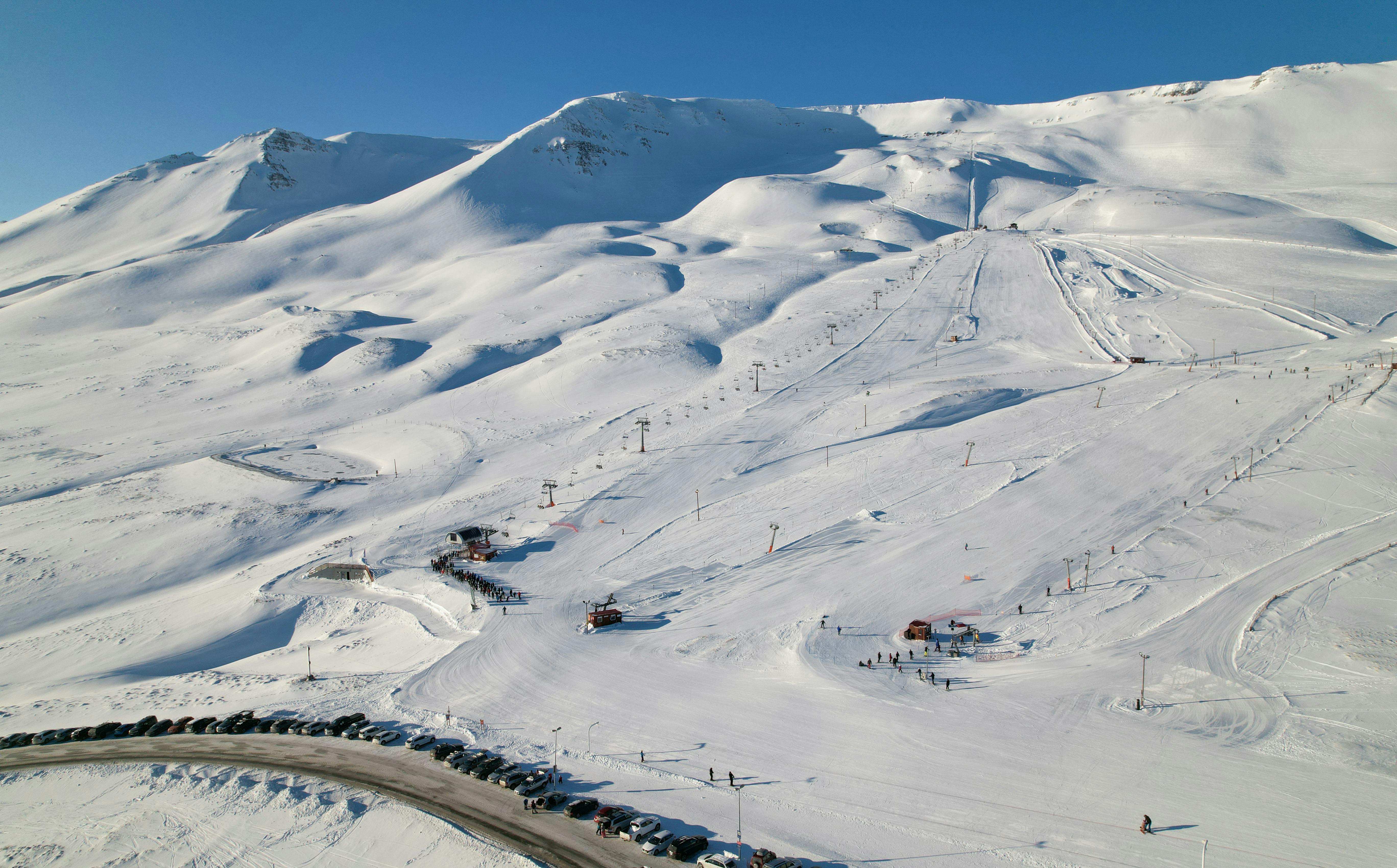 Stunning aerial shot of a snowy ski resort in Akureyri, Iceland. Ideal for winter sports enthusiasts.