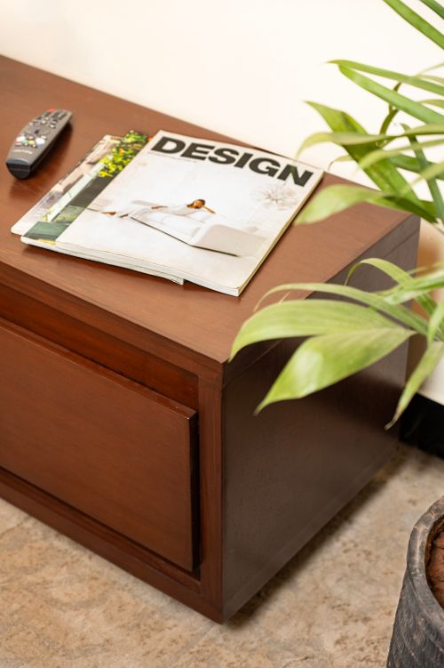 Free A sleek wooden coffee table with magazines and a potted plant, perfect for modern interiors. Stock Photo
