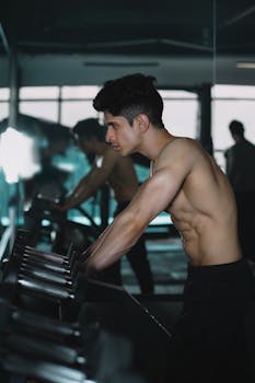 Young man in gym focusing on workout with determination and discipline.