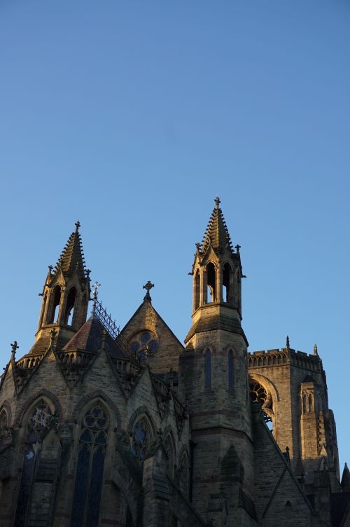 Free Stunning view of gothic cathedral spires against a clear morning sky in England. Stock Photo
