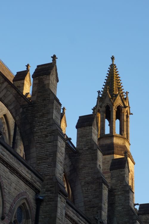 Free Explore the stunning Gothic architecture of a historical church in England at golden hour. Stock Photo